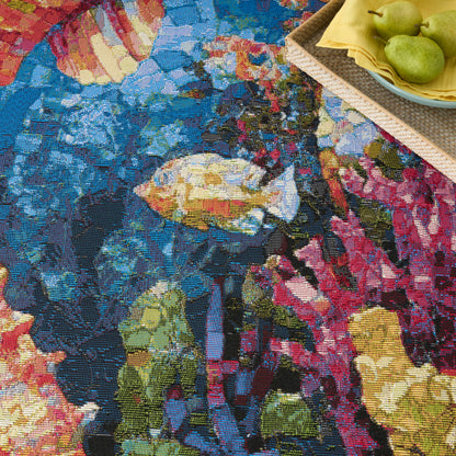 Colorful woven floral tapestry rug in blues, pinks and yellows; corner basket with pears on a yellow napkin.