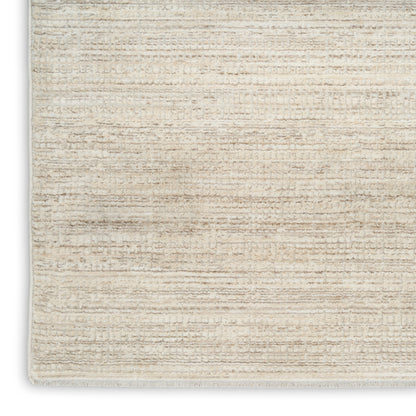 Cream-beige textured rug with subtle horizontal stripes and light fringe along the edge.