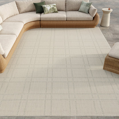 Beige modern rug with a light grid pattern; round side table visible nearby.
