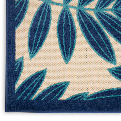 Teal blue palm leaf rug with cream background and navy border, close-up woven texture.