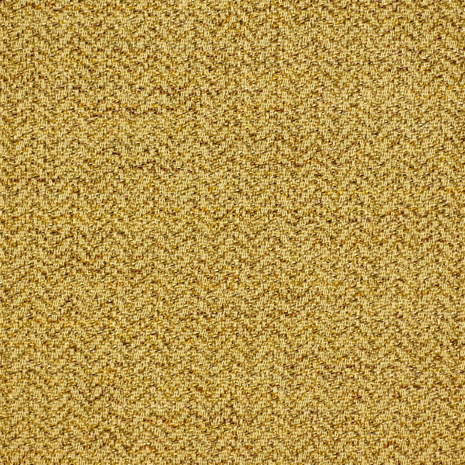 Close-up of golden-yellow textured fabric with boucle/tweed weave and speckled warm amber tones.