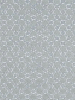 Soft blue-gray fabric with a repeating white ring pattern; geometric dotted circles perfect for textiles or wallpaper.