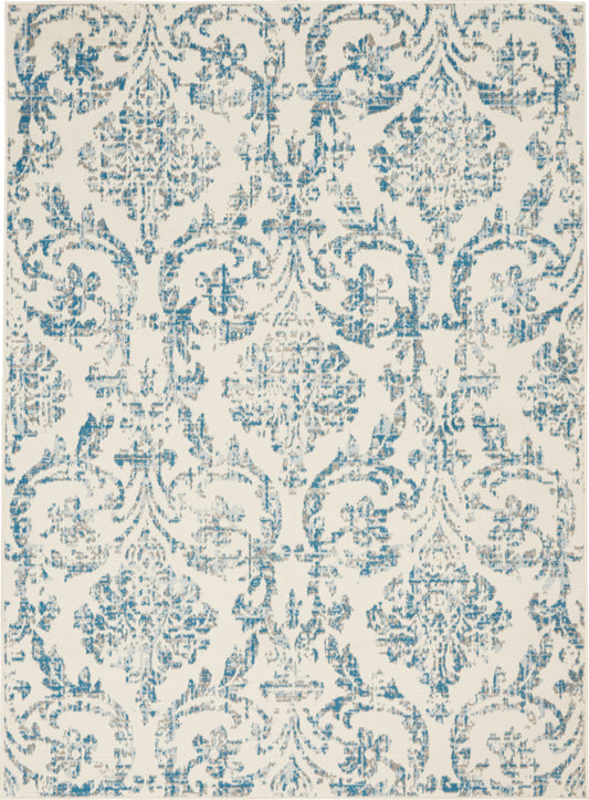 Blue damask-patterned rug with a distressed ivory background and ornate floral motifs.