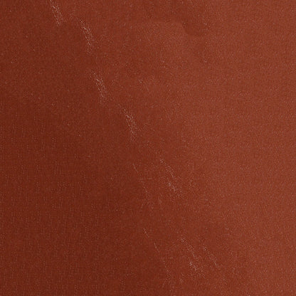 Close-up of orange distressed fabric with a rustic, textured weave.