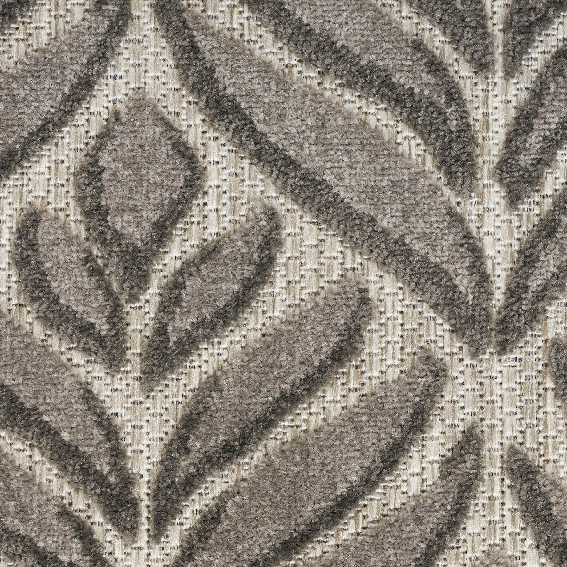 Taupe & cream outdoor runner rug with a bold leaf-like pattern & textured backdrop.