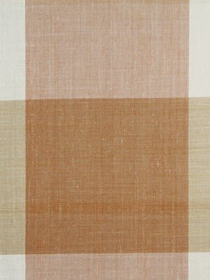 Woven textile with warm peach, tan and beige blocks in a bold geometric plaid; square orange-brown center.