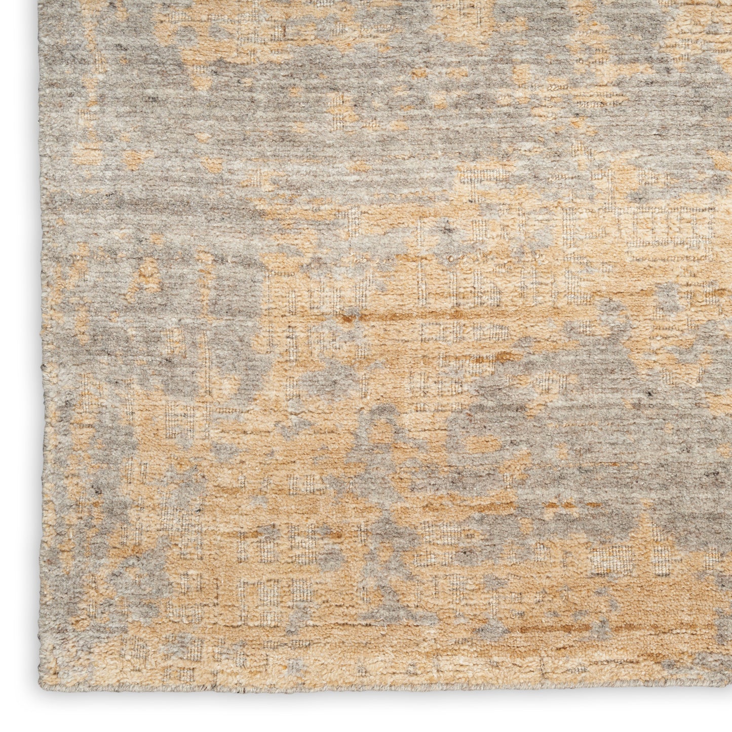 Distressed gray and beige area rug with subtle geometric pattern and soft, textured pile.