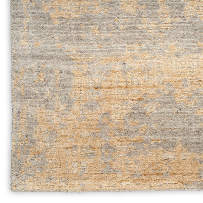 Distressed gray and beige area rug with subtle geometric pattern and soft, textured pile.