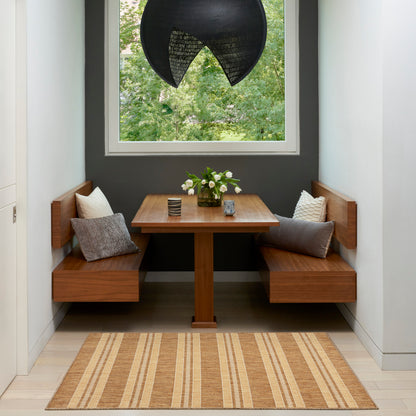 Wood dining nook with benches around a rectangular table, cushions, flower vase, black curved pendant lamp, striped rug.