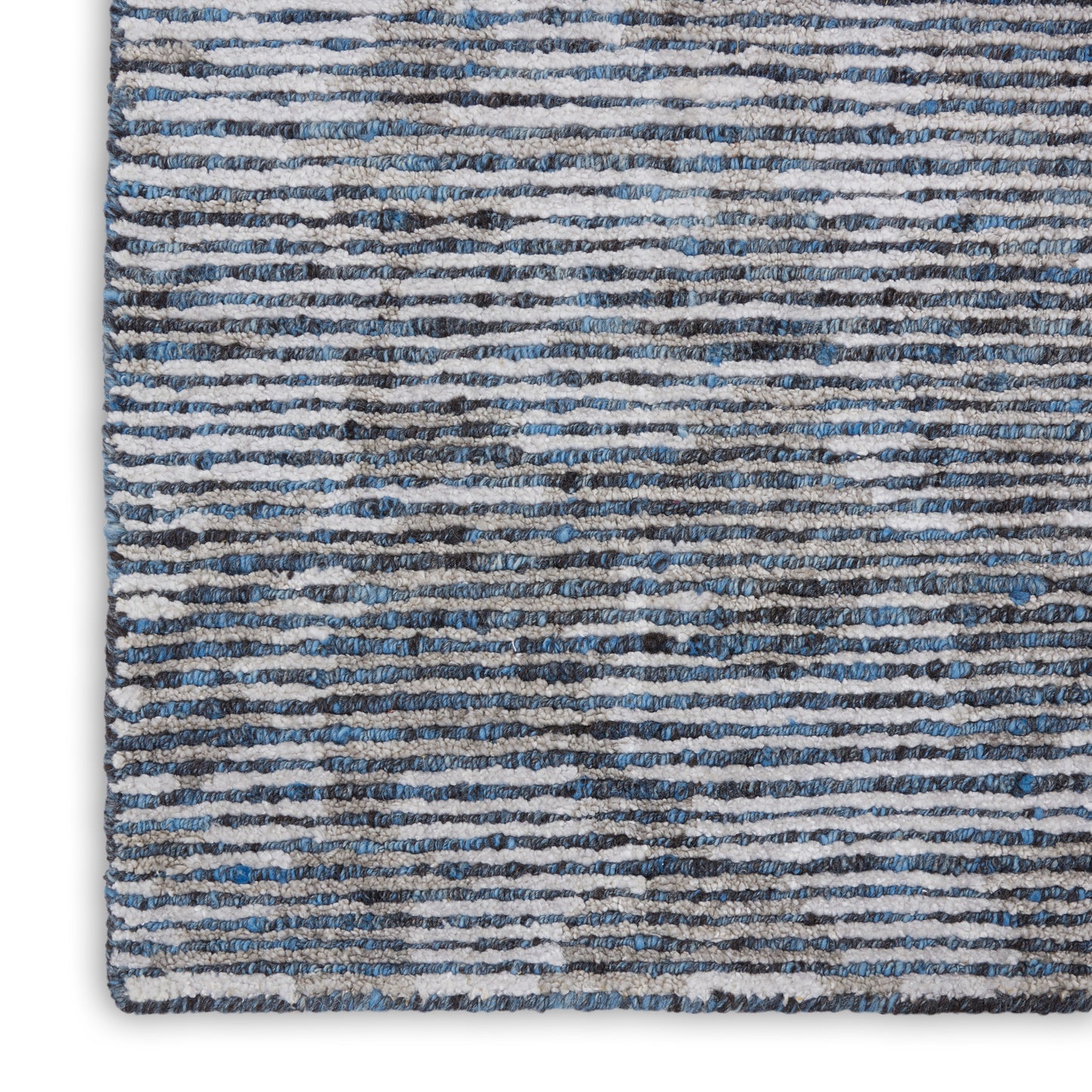 Blue-gray striped shag area rug with irregular white lines & plush pile.