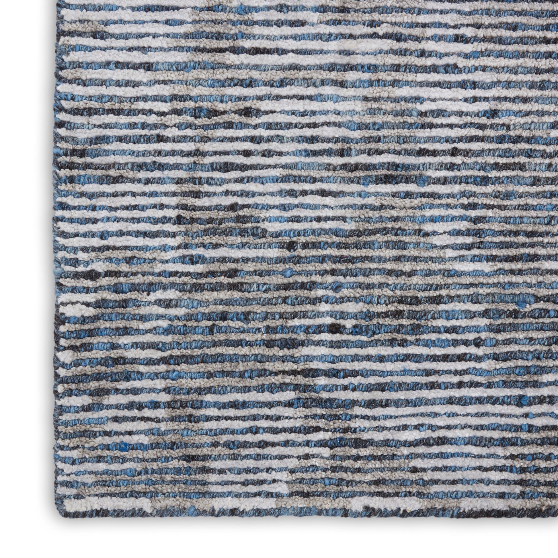 Blue-gray striped shag area rug with irregular white lines & plush pile.