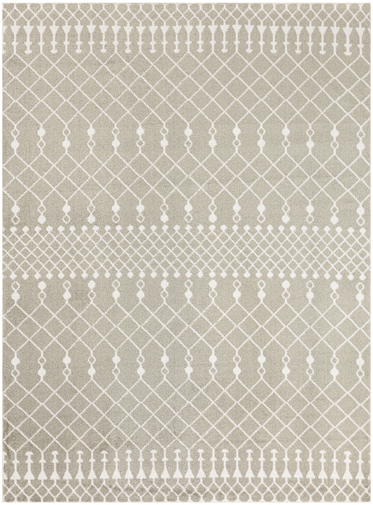 Beige area rug with a white repeating lattice pattern and dotted borders; geometric decorative rug.