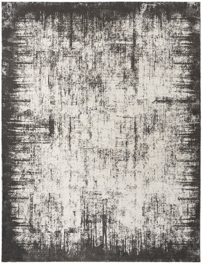 Abstract distressed area rug in ivory and charcoal with a dark border and painterly, textured pattern.