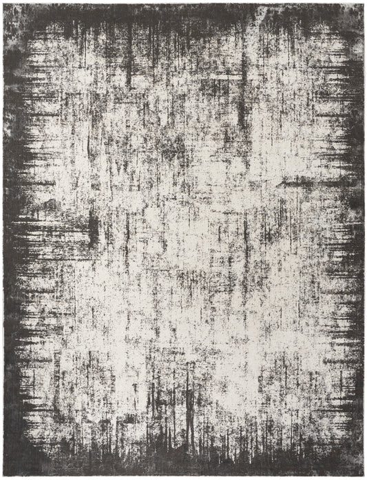 Abstract distressed area rug in ivory and charcoal with a dark border and painterly, textured pattern.
