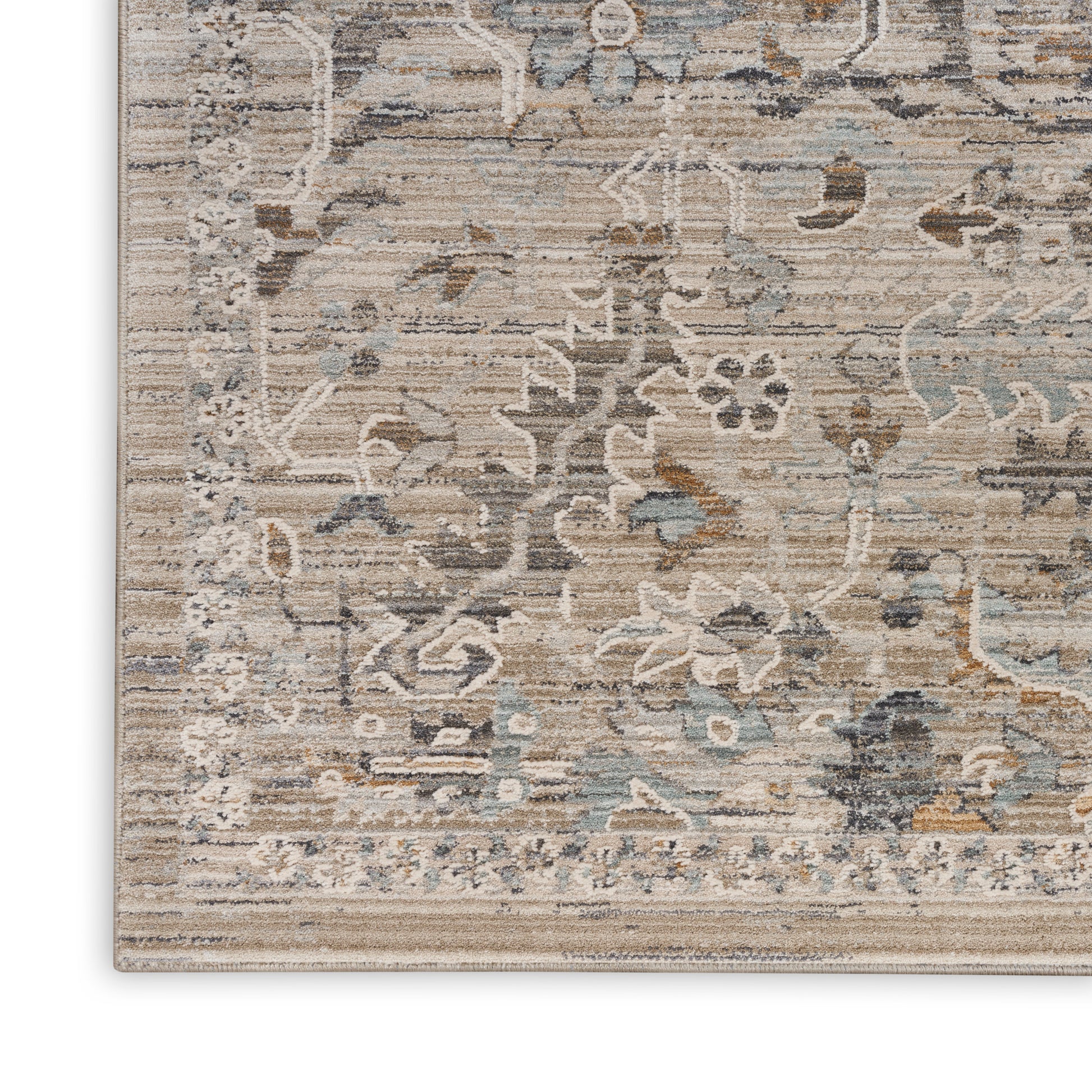 Distressed beige, blue, and gray oriental area rug with floral motifs and ornate border.