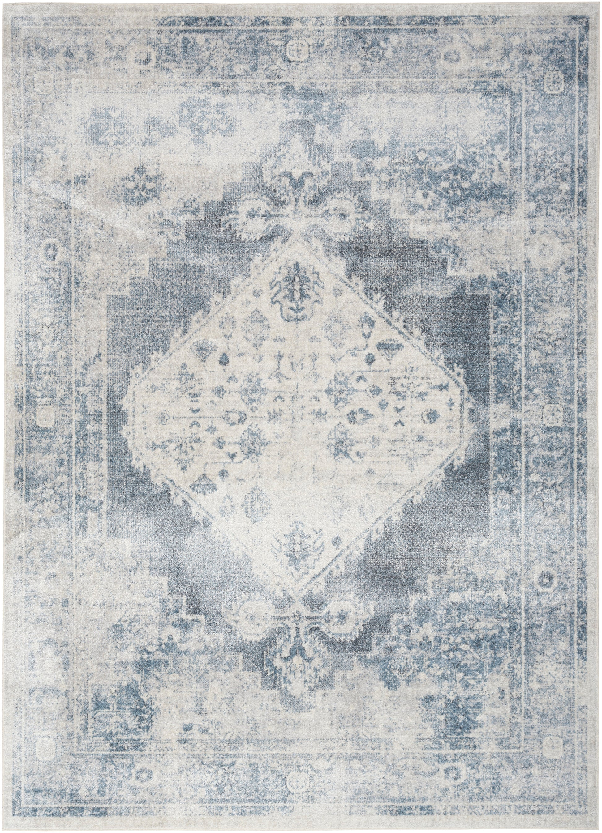 Distressed blue and ivory oriental area rug with a central diamond medallion and ornate border.