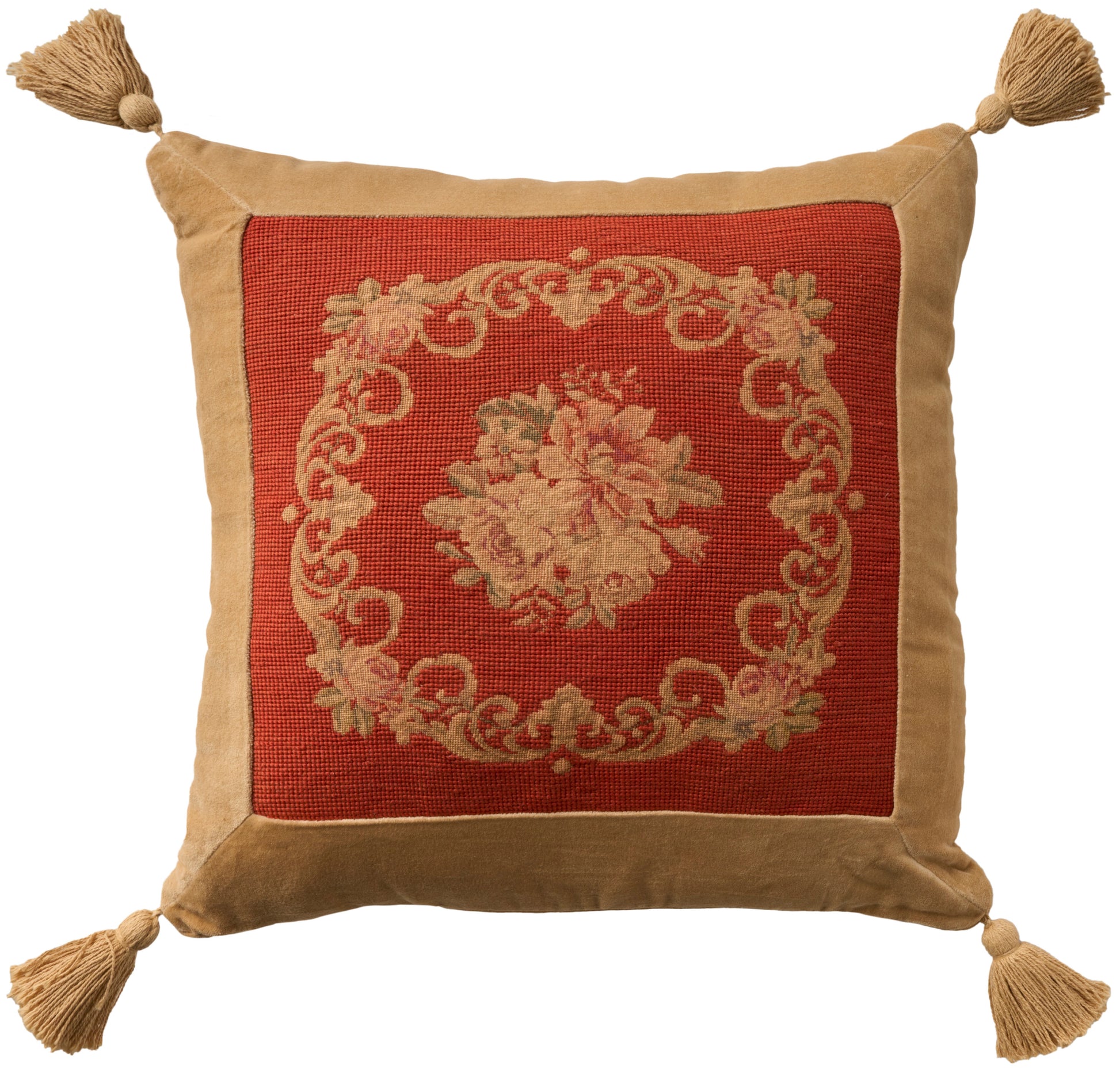 Decorative square throw pillow with red center panel, beige floral medallion, tan border, & tassels at all four corners.