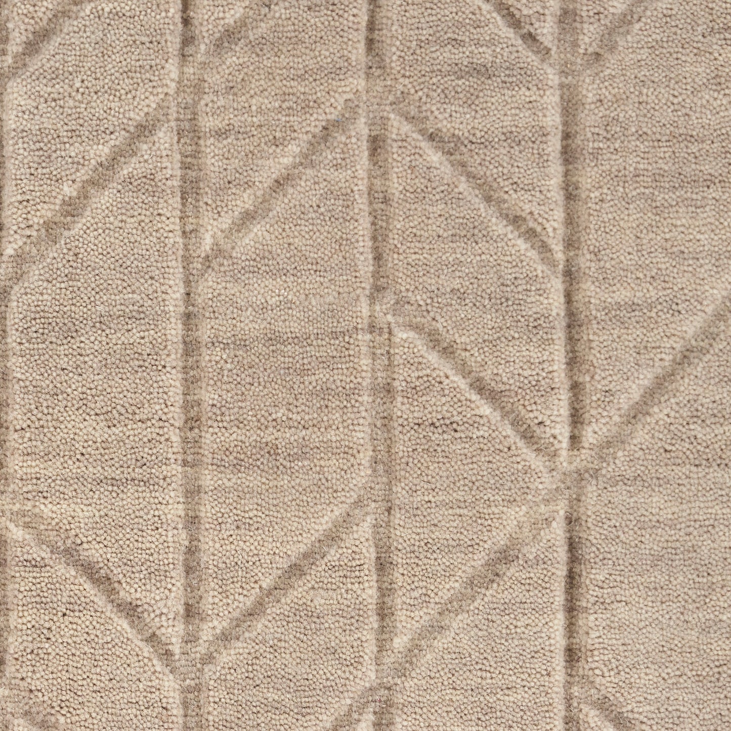Beige shag rug with subtle diamond geometric pattern and plush, soft pile.
