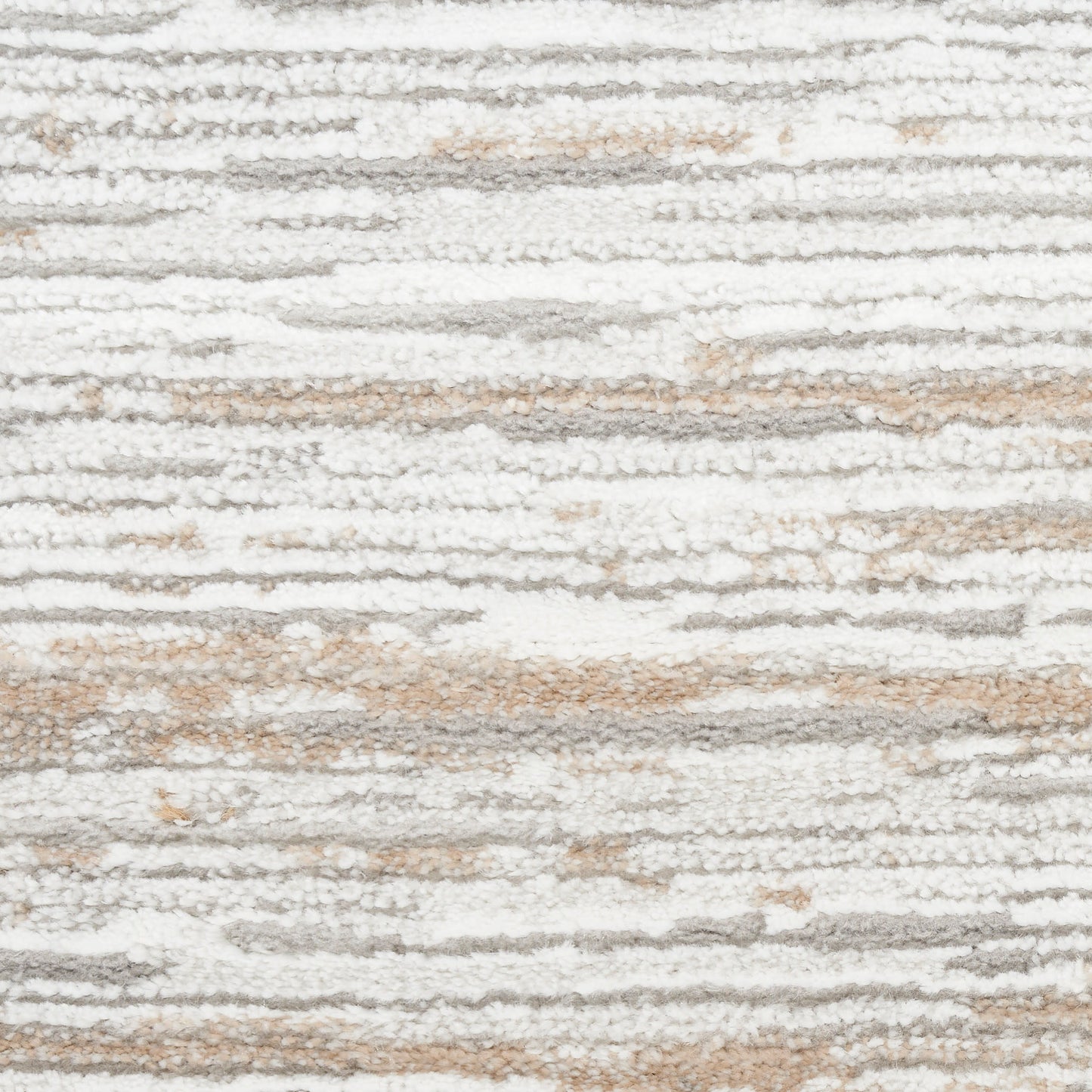Close-up of a soft, high-pile rug with white, gray and beige irregular striped pattern.
