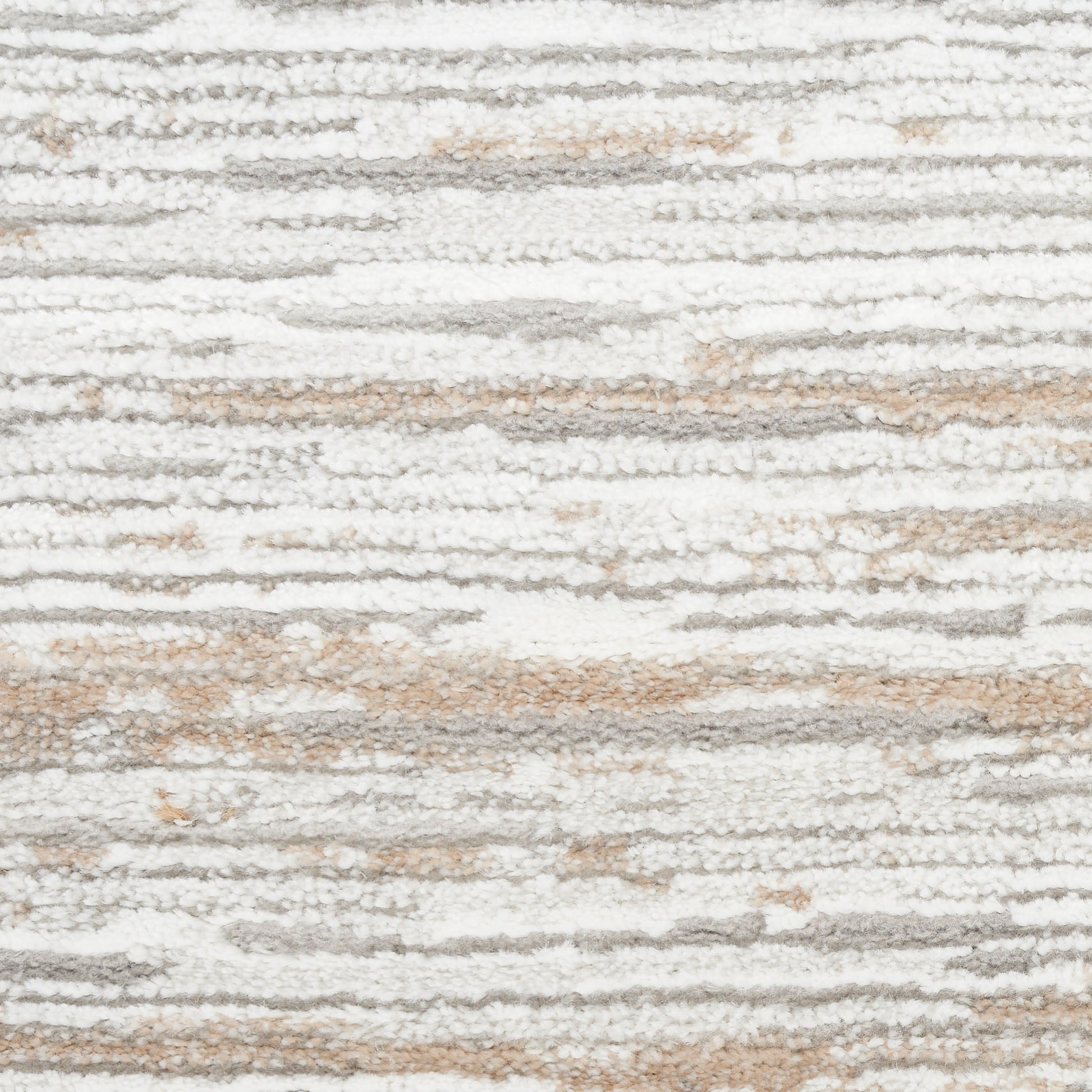 Close-up of a soft, high-pile rug with white, gray and beige irregular striped pattern.