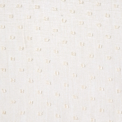 White woven fabric with subtle beige square dots in a dotted Swiss texture.