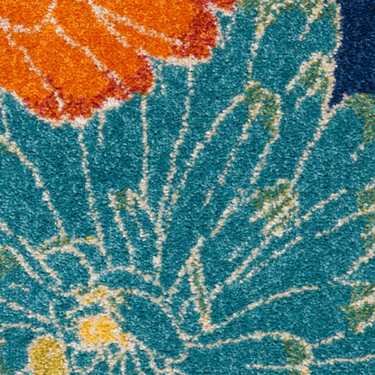 Shaggy turquoise rug with white radiating lines, orange floral motif & yellow accents; soft decorative area rug.