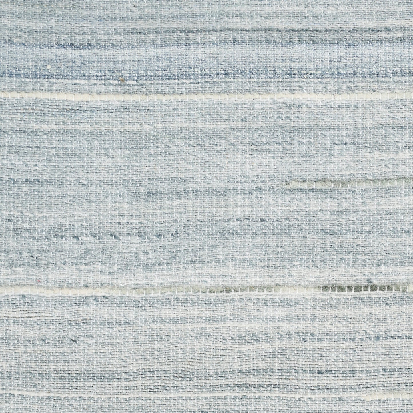 Light blue-gray woven fabric swatch with subtle horizontal stripes and textured weave.
