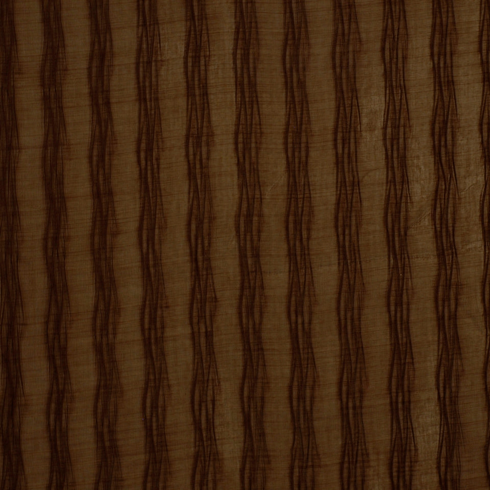 Brown textured fabric with repeating dark vertical wavy stripes on tan background.