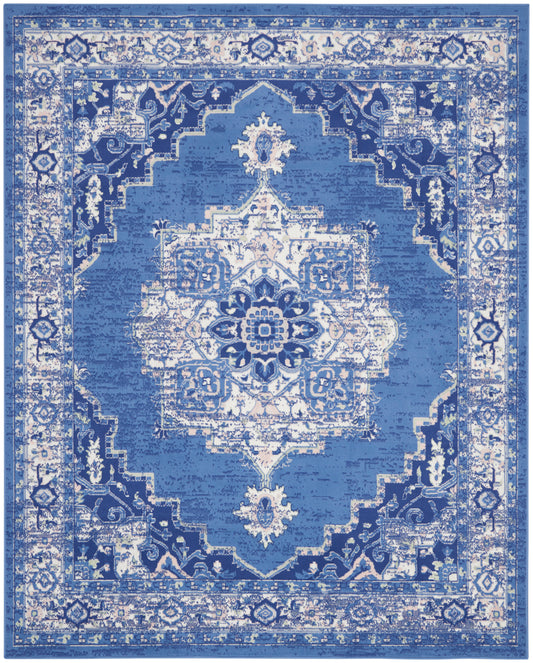 Blue distressed oriental rug with a white central medallion and ornate border pattern.