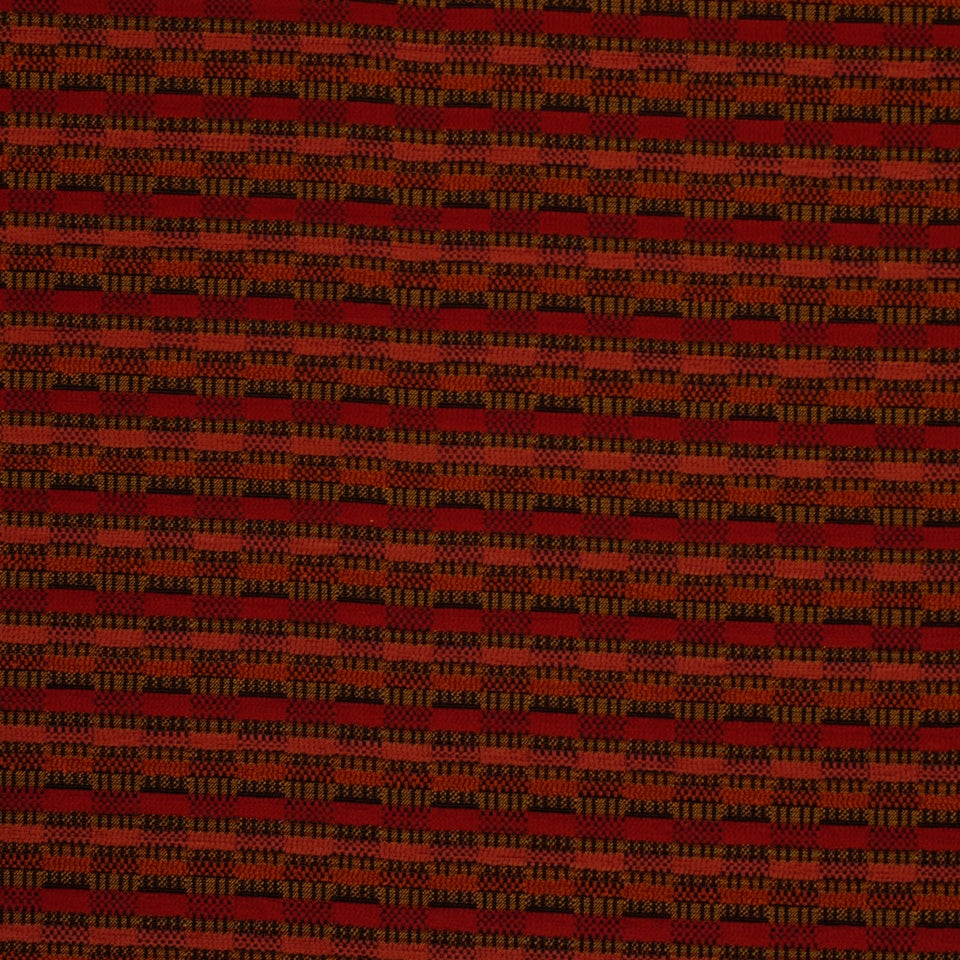 Red and black woven plaid upholstery fabric with small check blocks; rustic, versatile textile.