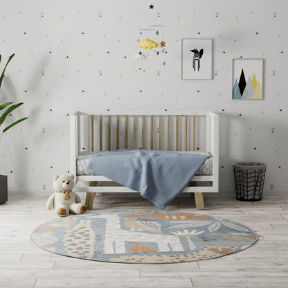 White wooden baby crib with pale blue blanket, round pastel rug, plush bear, plant, mobile with stars and clouds, and wall art.