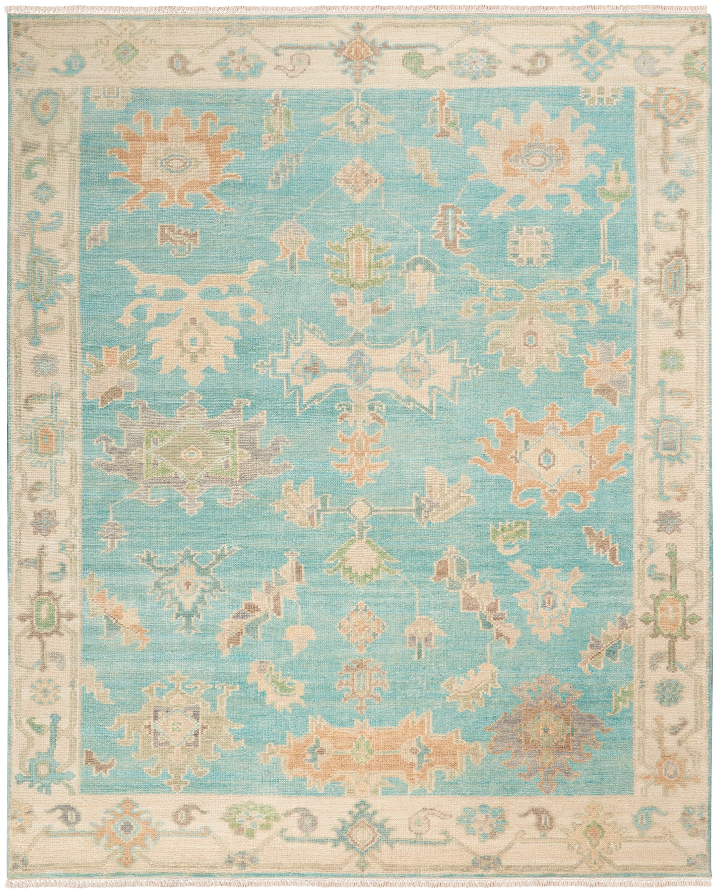 Turquoise oriental-style area rug with a cream border & pastel geometric motifs in peach, sage & ivory.