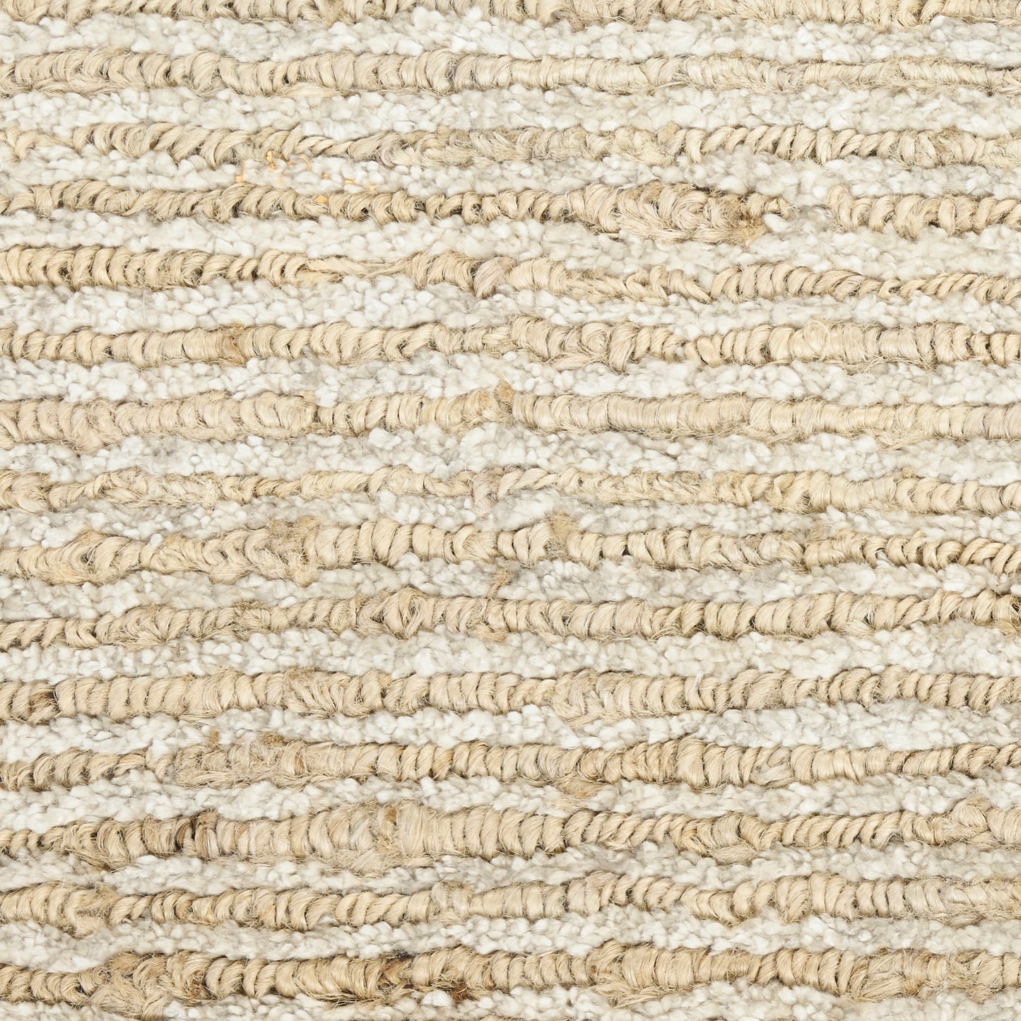 Cream and beige chunky woven rug with striped boucle texture; natural jute-like fibers, rustic coastal decor.