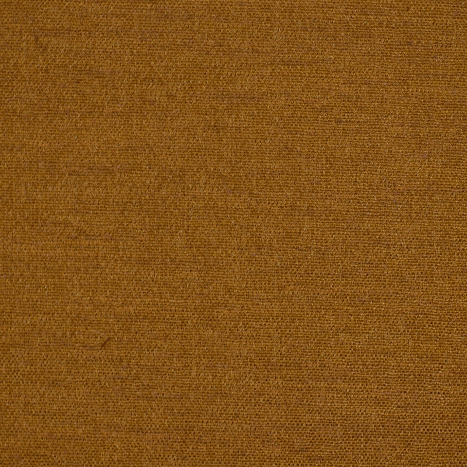 Close-up of warm brown woven fabric texture with tight weave and earthy textile feel.