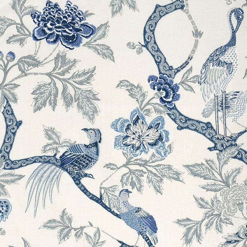 Blue and white chinoiserie wallpaper with peacocks and floral branches on a cream background.