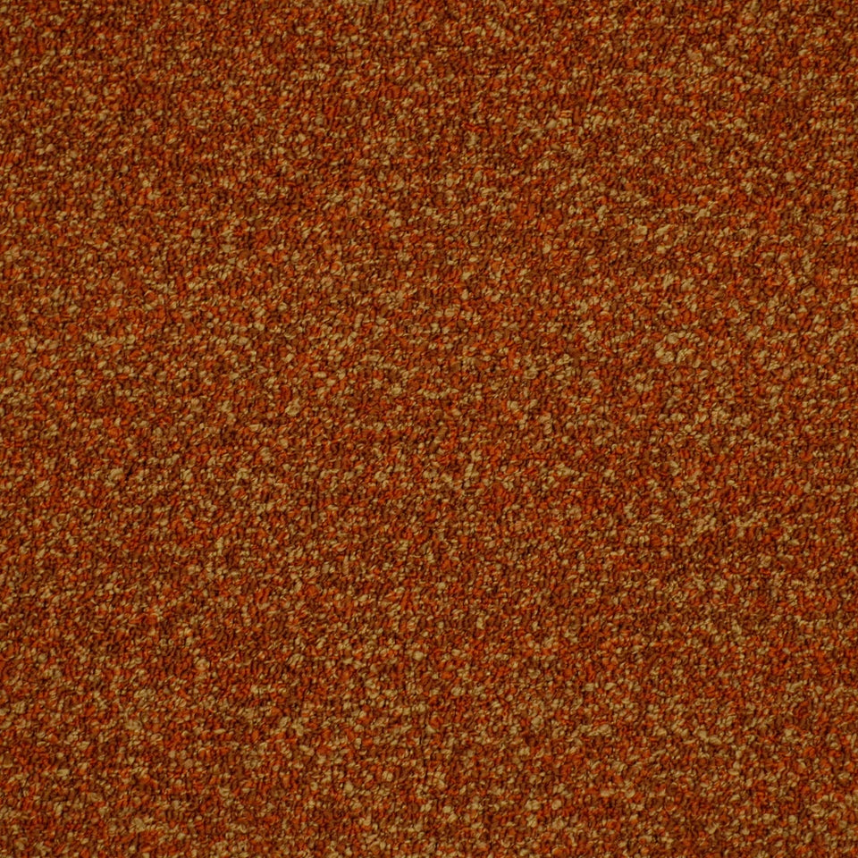 Close-up of rust-orange textured upholstery fabric with speckled tan flecks.