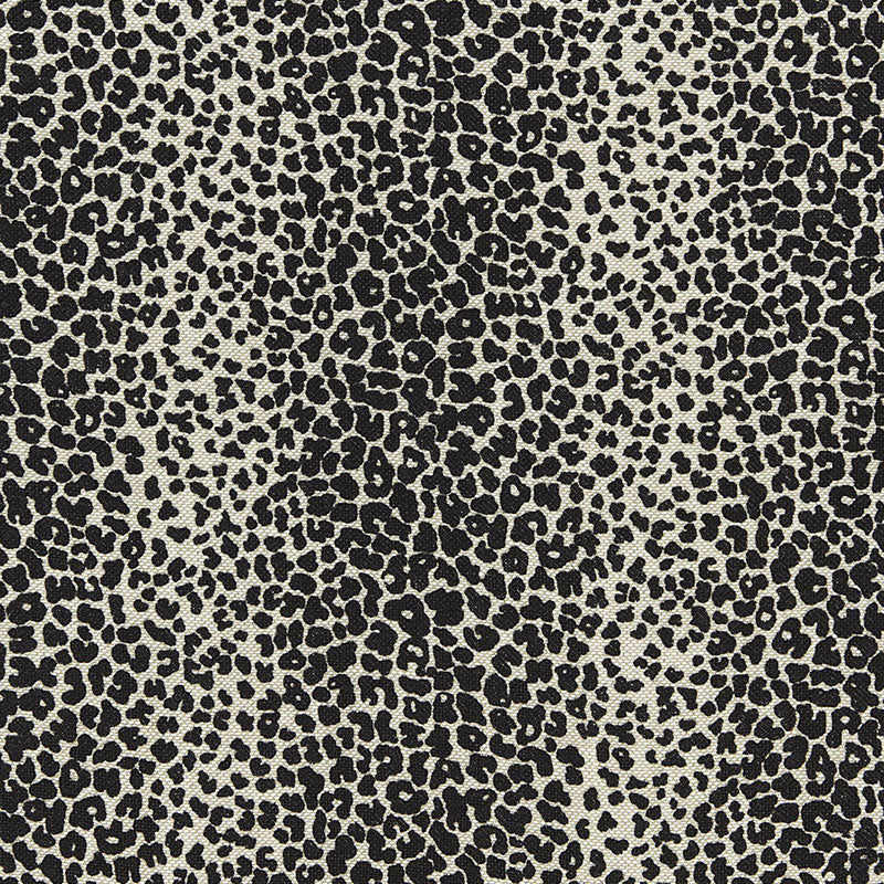 Beige fabric with black leopard print pattern; bold animal-print textile for apparel and accessories.