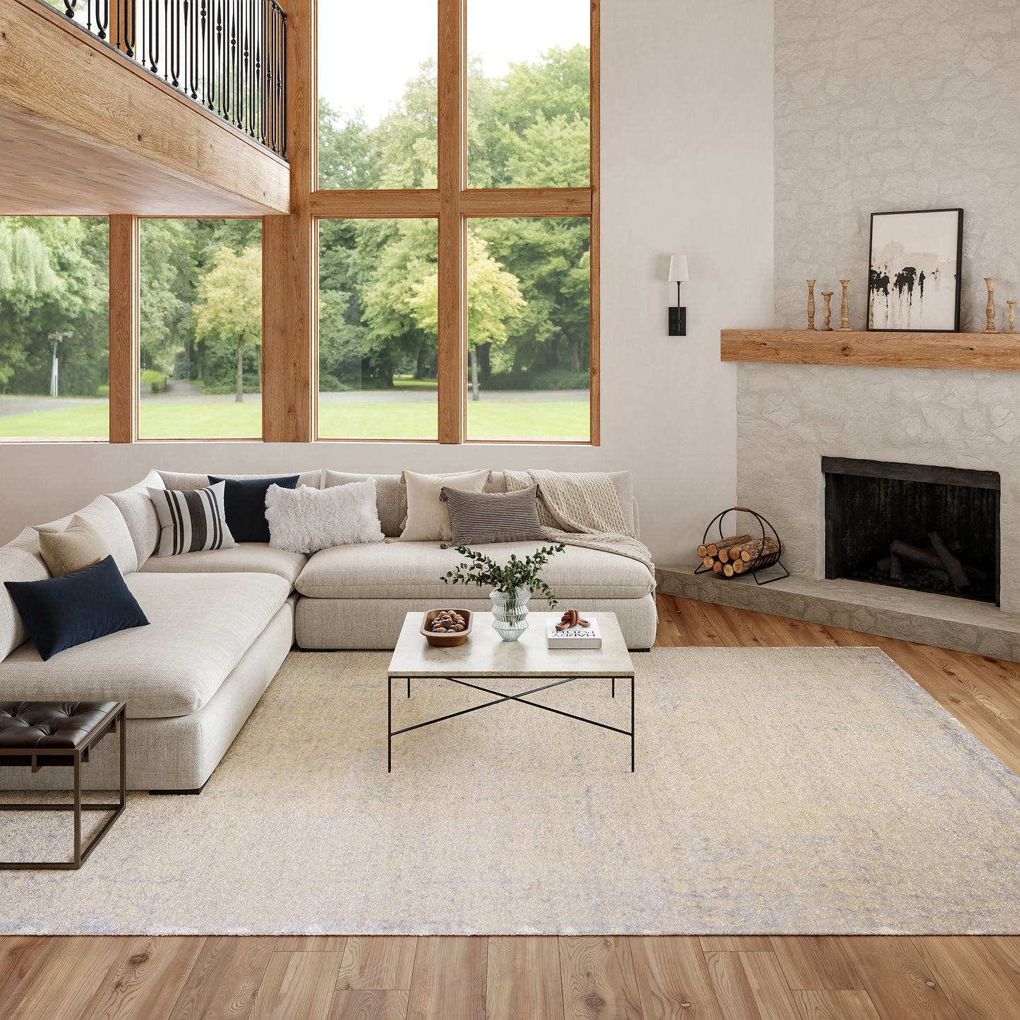 Beige sectional sofa with navy pillows, textured rug, glass coffee table, large wooden-framed windows, and a stone fireplace.