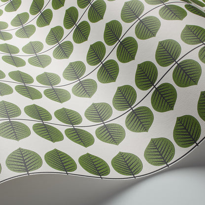 Curved white ceramic plate with repeating green leaf motifs along vines; abstract botanical design.