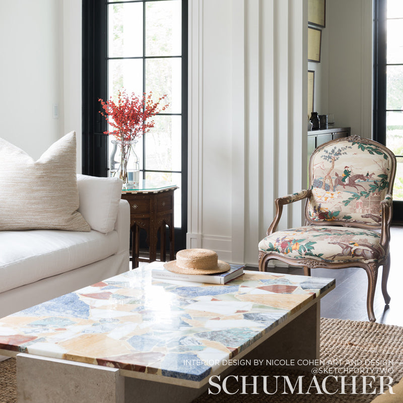 Colorful mosaic prints on a wall in a bright living room.