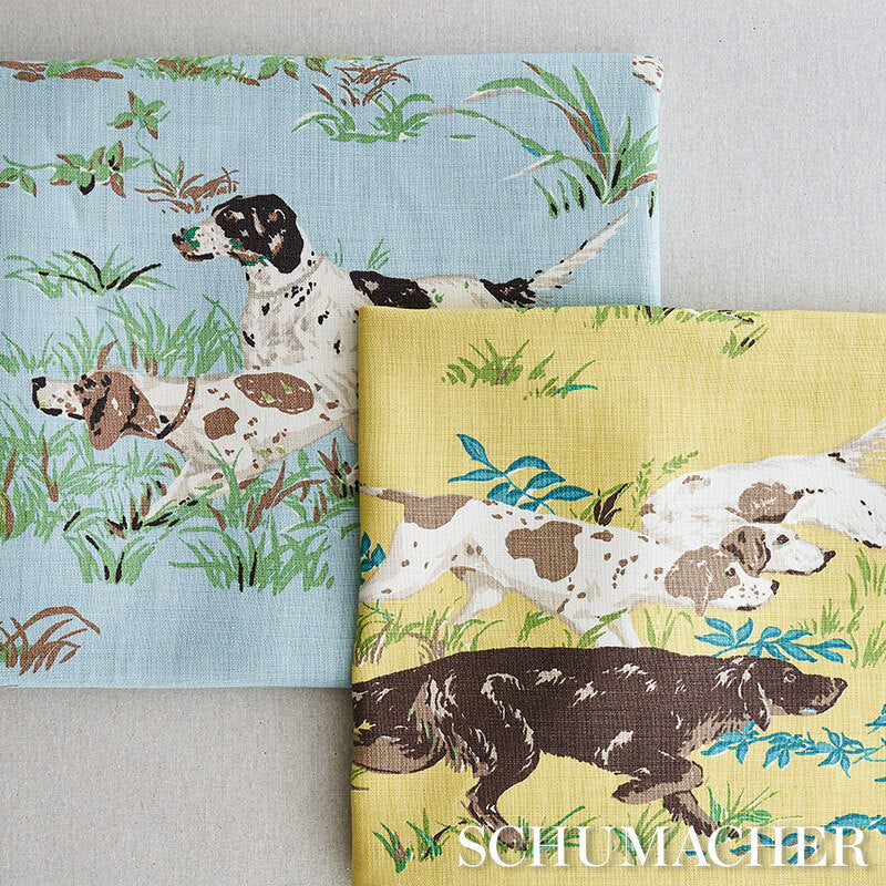 Cotton fabric with pointers print on blue and yellow backgrounds amid grassy scenes.