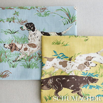 Cotton fabric with pointers print on blue and yellow backgrounds amid grassy scenes.