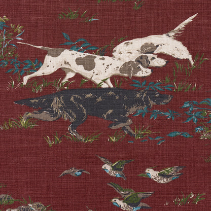 Maroon textile pattern with white and black-spotted dogs running through greenery and small blue birds.