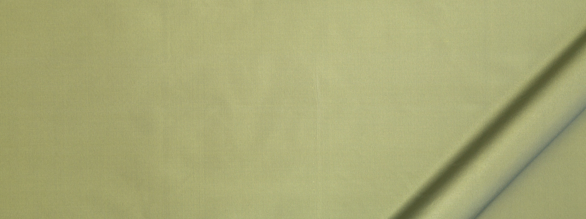 Olive-yellow fabric close-up with a diagonal crease, soft textile texture for clothing or home decor.