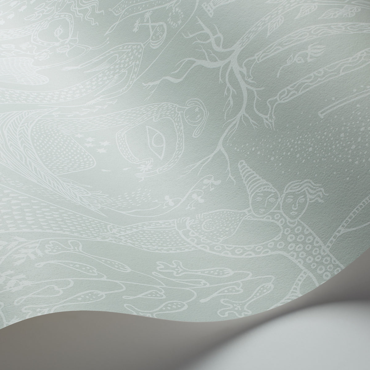 Mint green wallpaper with delicate white dragon & cloud motifs; curling corner reveals smooth paper texture.