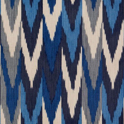 Ikat chevron textile in navy, royal blue, light blue, gray and cream with bold zigzag pattern.