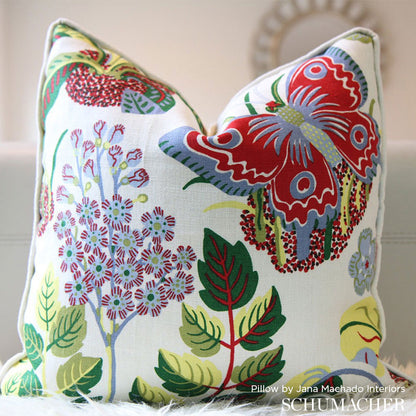 Colorful botanical throw pillow featuring a large red-and-blue butterfly among leafy flowers.