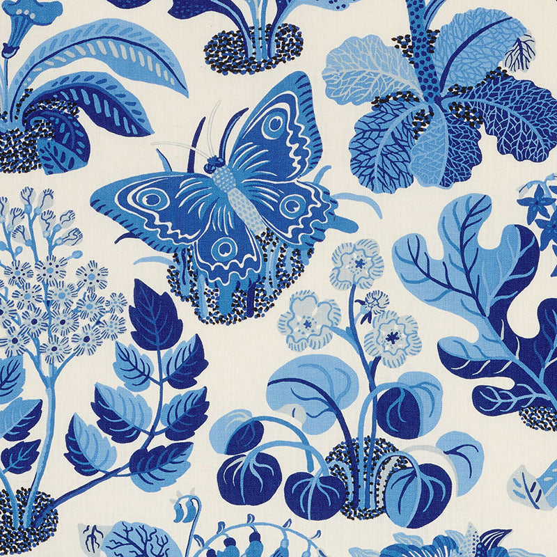Blue botanical and butterfly pattern on cream fabric, featuring stylized leaves and flowers.