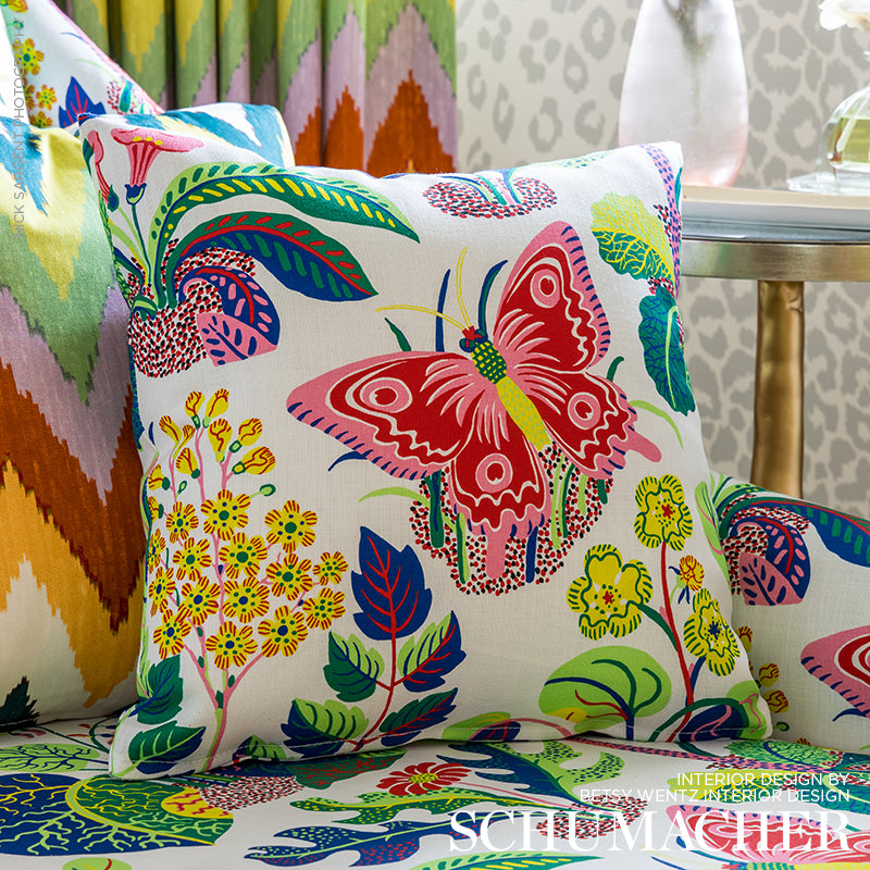 Exotic butterfly and floral print on white linen fabric; vibrant greens, pinks, and blues in a tropical design.