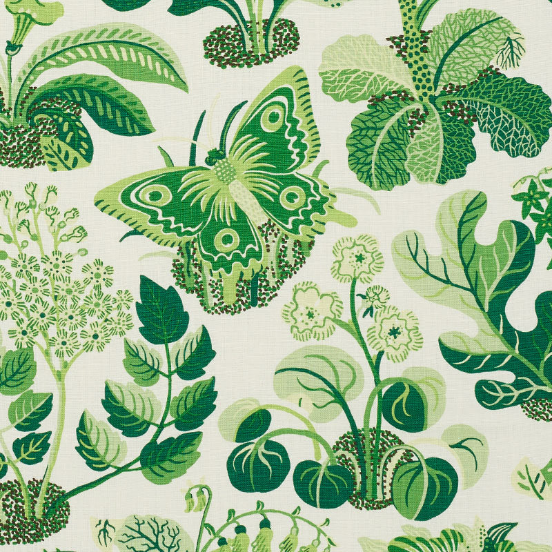Green butterfly among lush botanical leaves on ivory fabric.